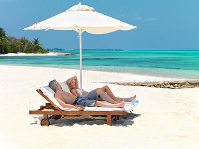 Mature couple relaxing on deck chair