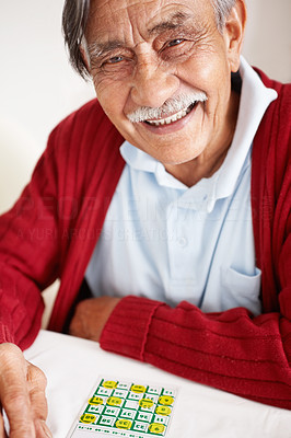 Elderly happy man playing bingo