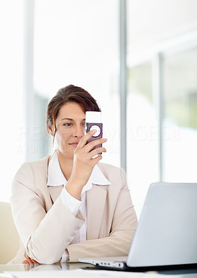 Middle aged business woman reading a text message at office