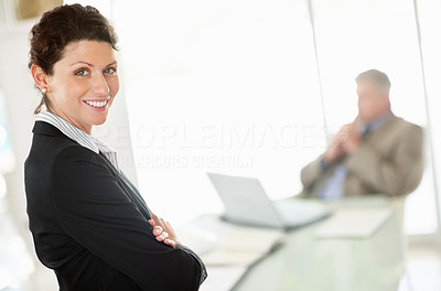 Happy middle aged business woman with hands folded