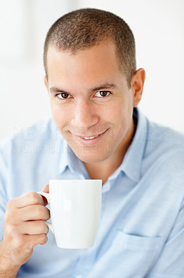 Happy middle aged man holding a cup of tea or coffee