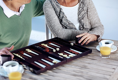 Senior couple playing a game of backgammon - Cropped