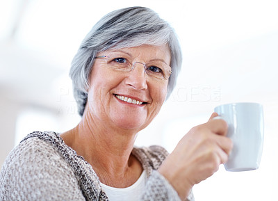Retired smiling senior woman drinking coffee