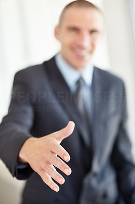 Blur middle aged business man giving you a handshake