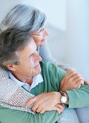 Retired senior couple looking away in thought