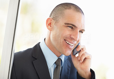 Middle aged business man using mobile phone and smiling