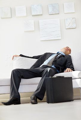 Tired middle aged business man sleeping on sofa