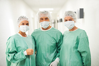 Team of surgeons in scrubs standing together