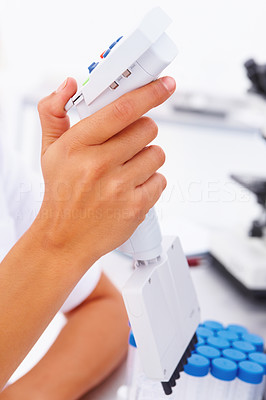 Teenager\'s hand using laboratory equipments