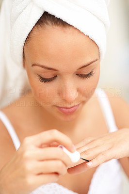 Closeup portrait of young female polishing nails