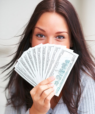 Portrait of young female her face with money