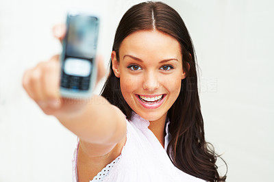 Young girl showing her mobile isolated over white background