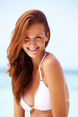 Beautiful young bikini model smiling outdoors