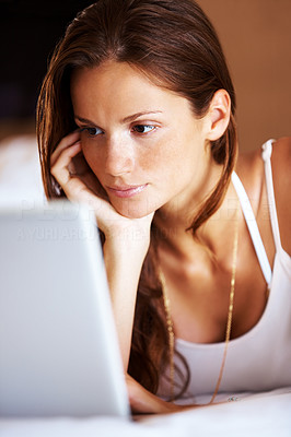 Pretty lady seriously working on laptop