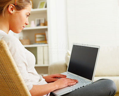Busy woman sitting in chair and working on laptop