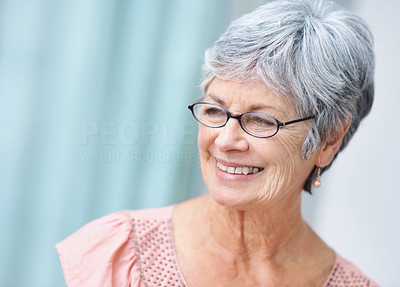 Closeup of a happy senior woman smiling in thought