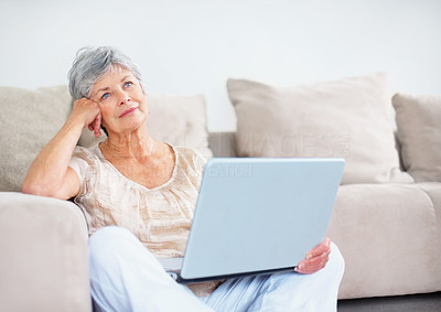 Senior woman with a laptop but lost in thought