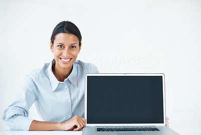Confident female executive showing laptop