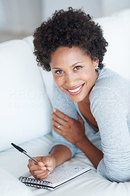 Woman writing diary at home