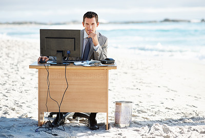 Happy middle aged business man working on computer at his desk