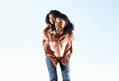 Woman giving piggyback ride to daughter