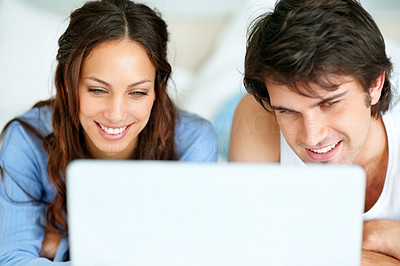 Closeup of happy young couple using a laptop
