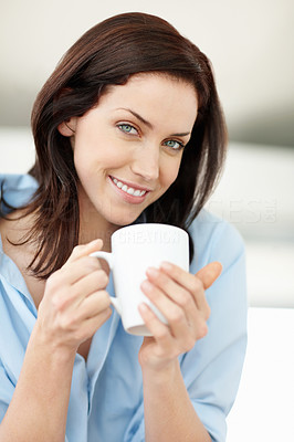Happy Caucasian woman holding a cup of tea or coffee