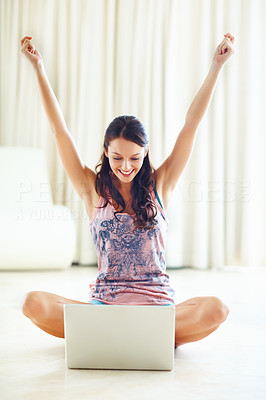 Excited young woman with laptop