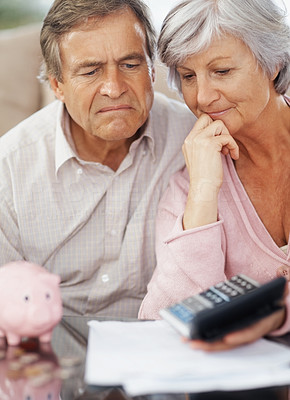 Senior couple calculating their monthly expenses at home