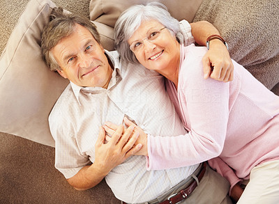 Top View of a happy senior couple lying together on the floor