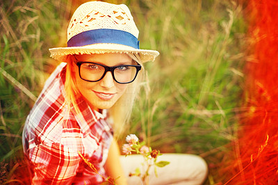 Lomo-style portrait of a young hipster woman in a field