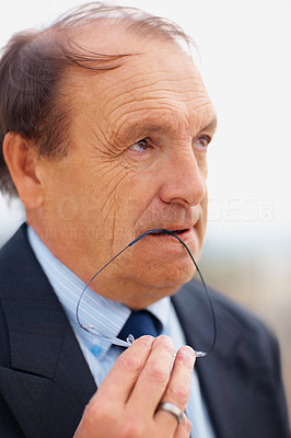 Closeup of a senior business man thinking over something