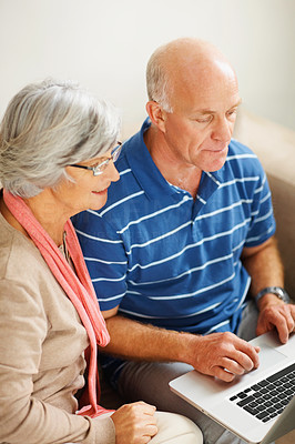 Top view of a senior man and woman using a computer laptop
