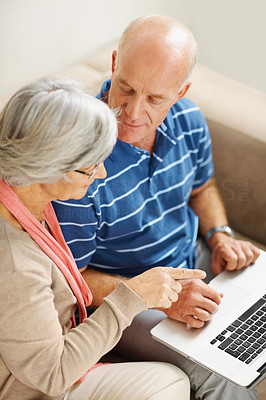 Senior man and woman using a computer laptop