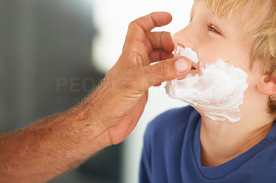 Showing him the ropes of shaving