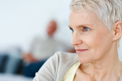 Closeup of an elderly lady looking away lost in thought