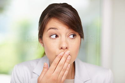 Surprised woman with hand over mouth