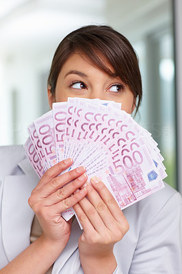 Female holding a fan of money over face , five hundred Euros