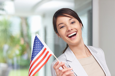 Happy young woman holding an American flag