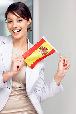 Attractive happy young woman holding a Spanish flag