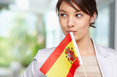 Elegant young woman holding a Spanish flag
