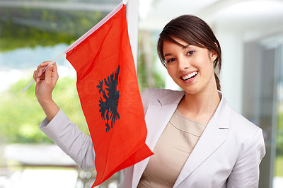 Lovely young woman holding an Albanian flag