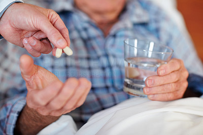 Closeup of a senior man being given a life saving pill