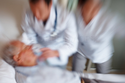 Blurred image a senior man being treated for a heart attack