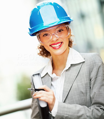 Portrait of happy cute female architect holding a project file