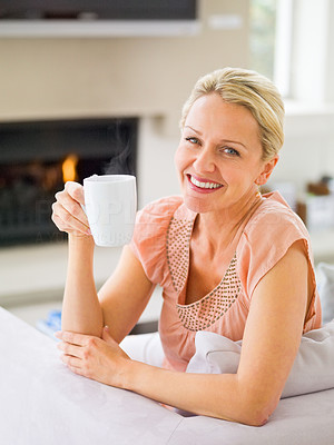 Pretty mature woman having a cup of coffee