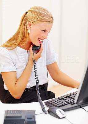 Secretary using a telephone in office