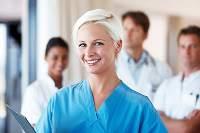 Happy young female nurse smiling at hospital