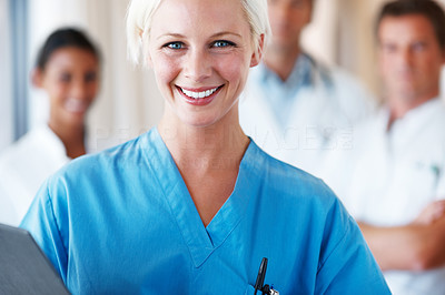 Young female nurse smiling with a report file