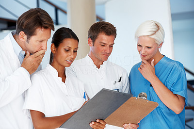 Doctor and nurses going through a report